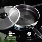 Stainless steel frying pan with non-stick surface on a stove, featuring text about non-stick effect.

