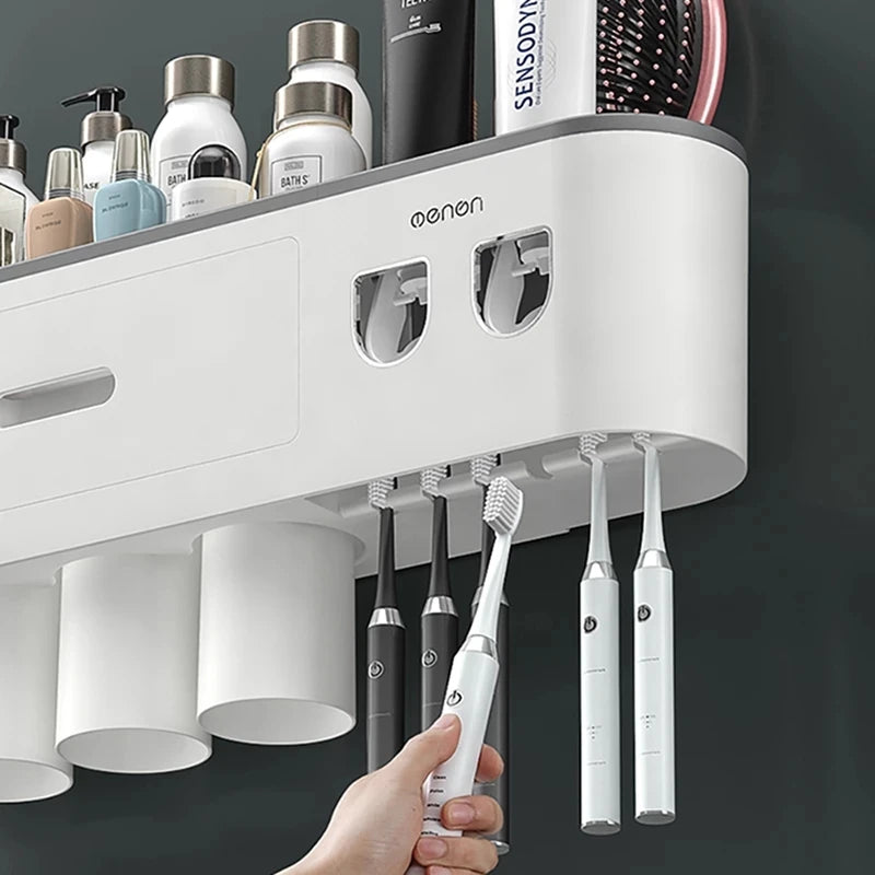 White electric toothbrush charging station with multiple toothbrushes and a hand holding a toothbrush.

