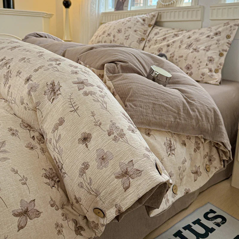 Floral patterned bedding on a bed in a bedroom setting

