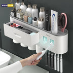 Wall-mounted bathroom organizer with toothbrush holder, toiletries, and a hand holding a toothbrush.

