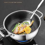 Stainless steel wok with fish and vegetables on a portable stove

