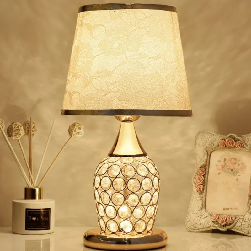 Decorative table lamp with textured shade and ceramic base on a neutral background

