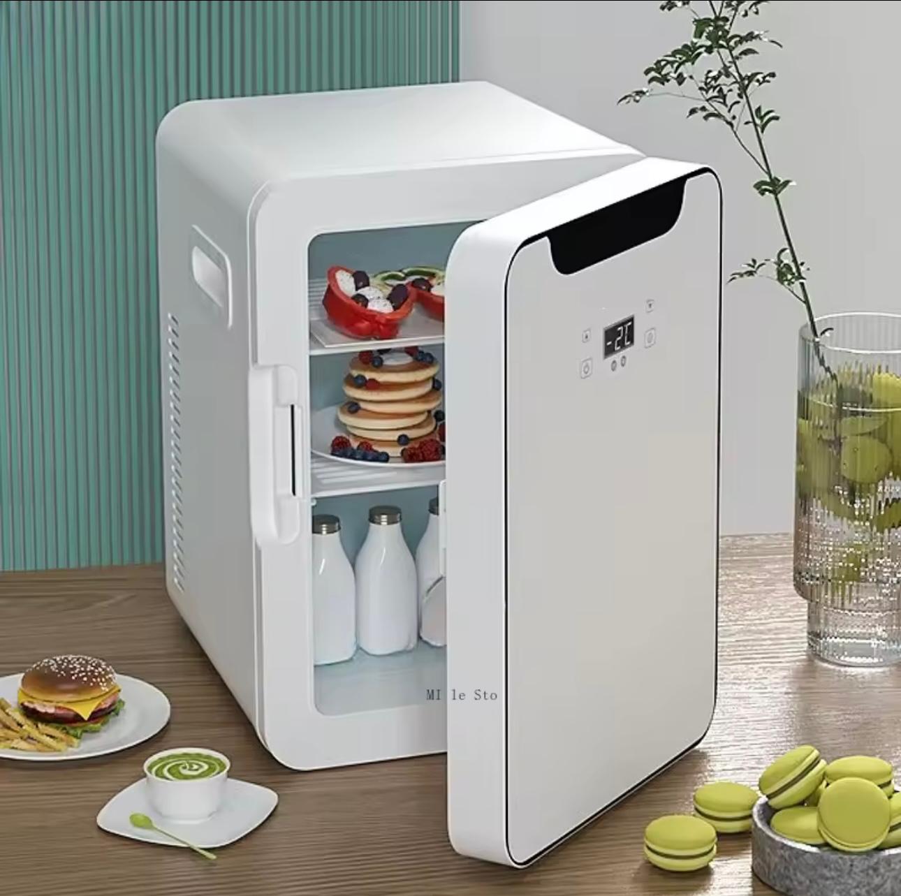A compact white mini refrigerator with its door open, shown on a tabletop with food items inside and around it, including pancakes with fruit, milk bottles, a burger, macarons, and a glass of iced tea.

