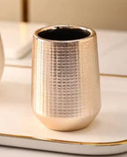 A small cylindrical metallic holder