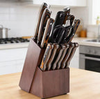 A dark wood block knife stand holding a set of kitchen knives, shears, and utility tools, placed on a light wood countertop in a blurred kitchen setting.

