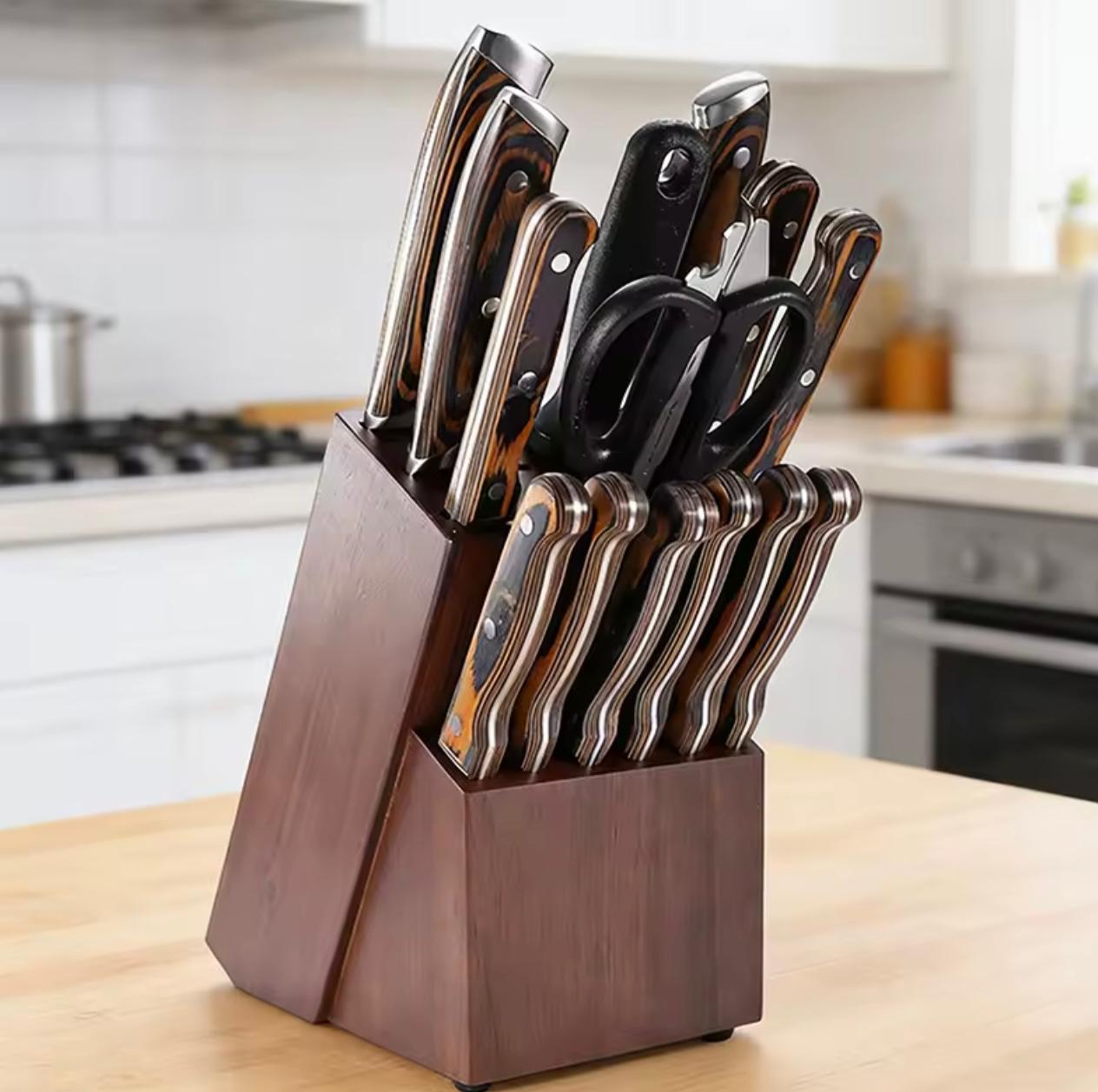 A dark wood block knife stand holding a set of kitchen knives, shears, and utility tools, placed on a light wood countertop in a blurred kitchen setting.

