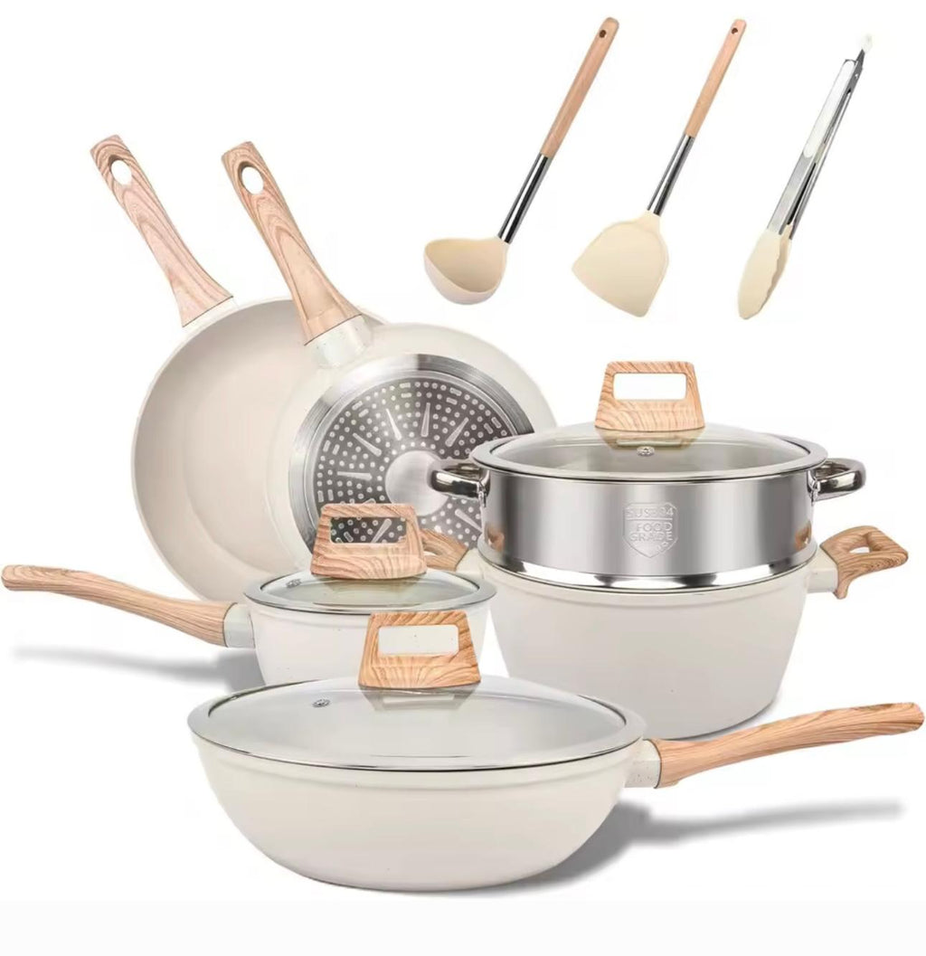 A 7-piece ceramic non-stick cookware set with light wood handles and lids, including a deep pot, two saucepans, a grater, and three utensils, displayed on a clean white background.

