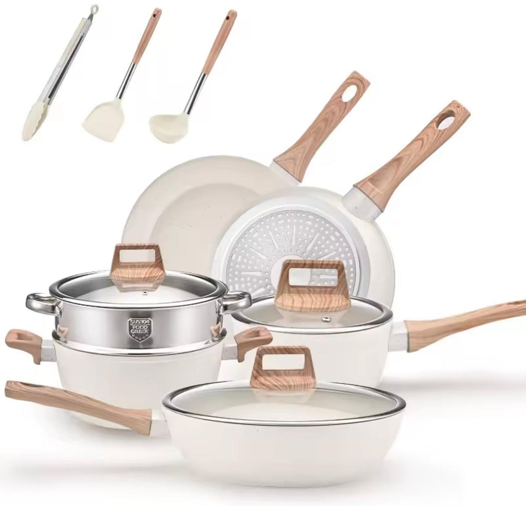 A 12-piece white non-stick cookware set with light wood handles and lids, shown with three matching utensils (spoon, spatula, and ladle) on a clean white background.

