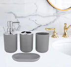 Gray bathroom vanity set including a soap dispenser, cup, tumbler, and soap dish, shown on a white marble countertop with a gold faucet.

