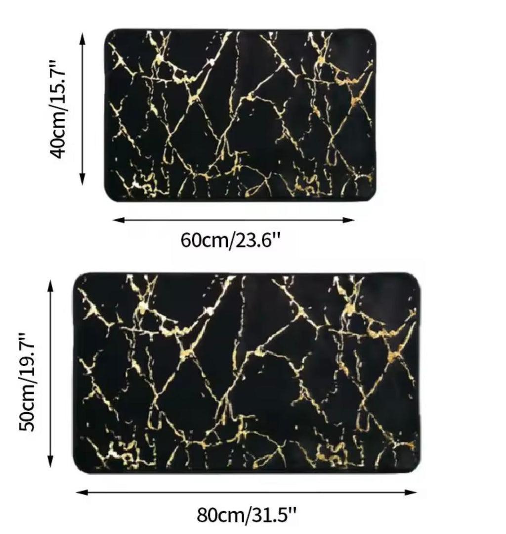 Two rectangular black mats with a gold marble vein pattern, shown with dimension labels indicating 60cm by 40cm and 80cm by 50cm sizes on a white background.


