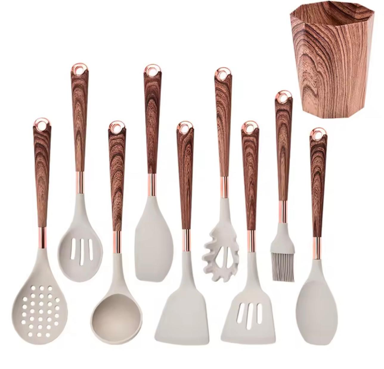 An 8-piece silicone kitchen utensil set with dark brown wood-grain handles and rose gold metal collars, shown alongside a matching wooden cutting board on a white background.

