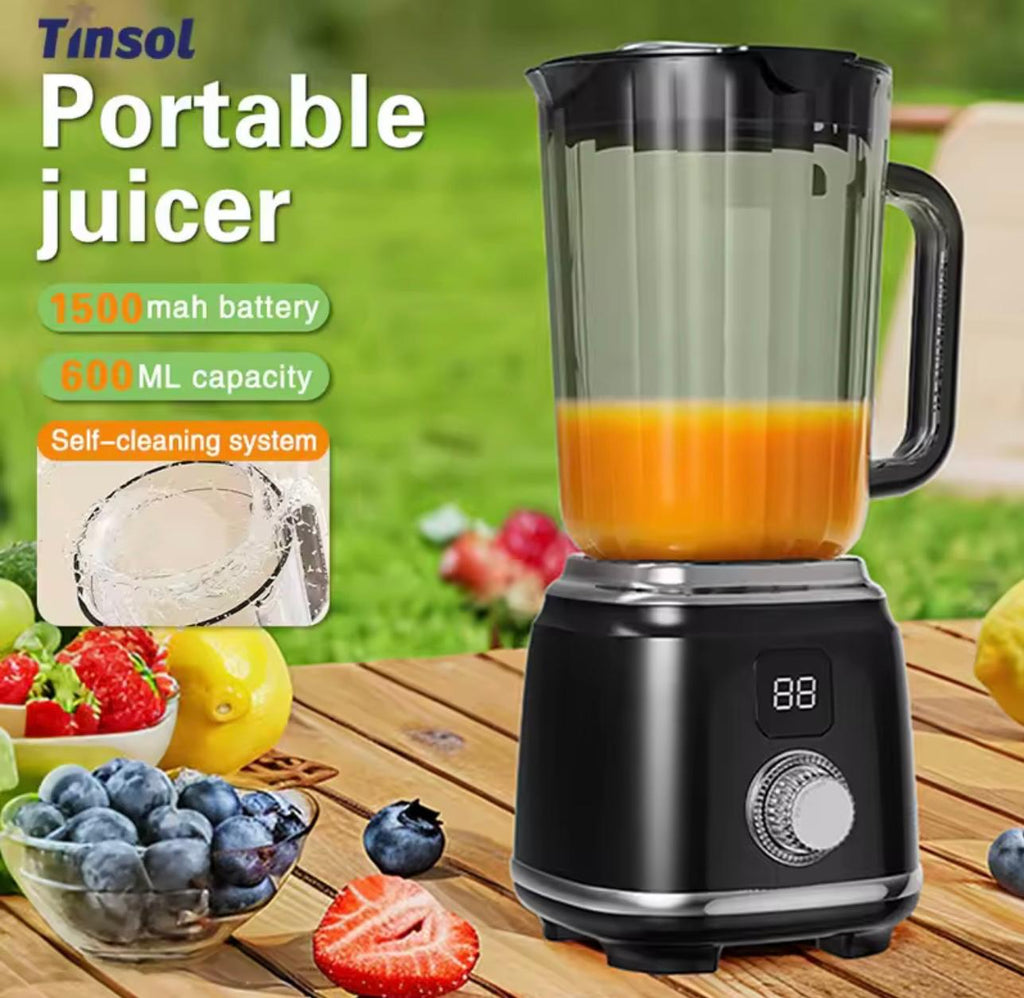 Tinsol portable blender with a black base and clear jar containing orange juice, shown on a wooden table with fruits and a grassy outdoor background. Text on the left highlights 1500 mah battery, 600 ML capacity, and self-cleaning system.

