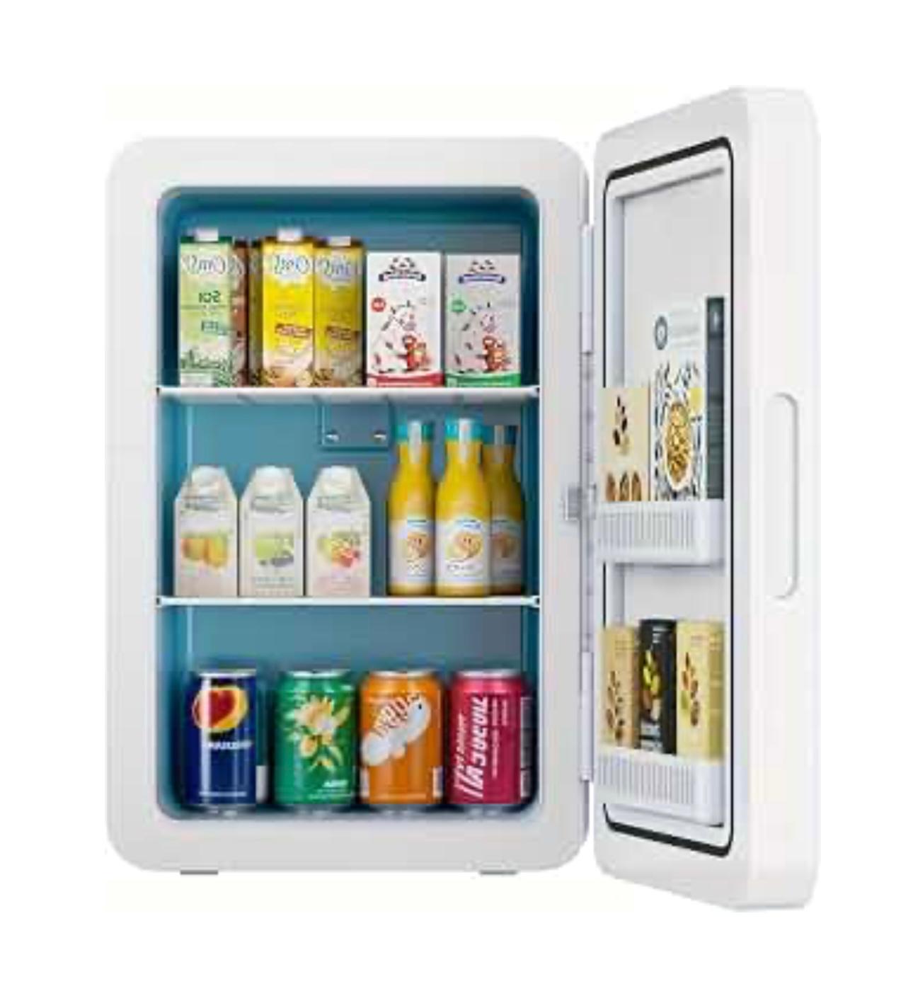 A small white portable refrigerator with its door open, showing three shelves stocked with milk cartons, juice bottles, canned sodas, and boxed goods. The interior has a blue lining, and the door pocket holds additional items.

