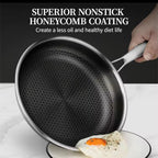 A hand holds a nonstick frying pan over a plate with a fried egg, with text at the top reading 'SUPERIOR NONSTICK HONEYCOMB COATING'.

