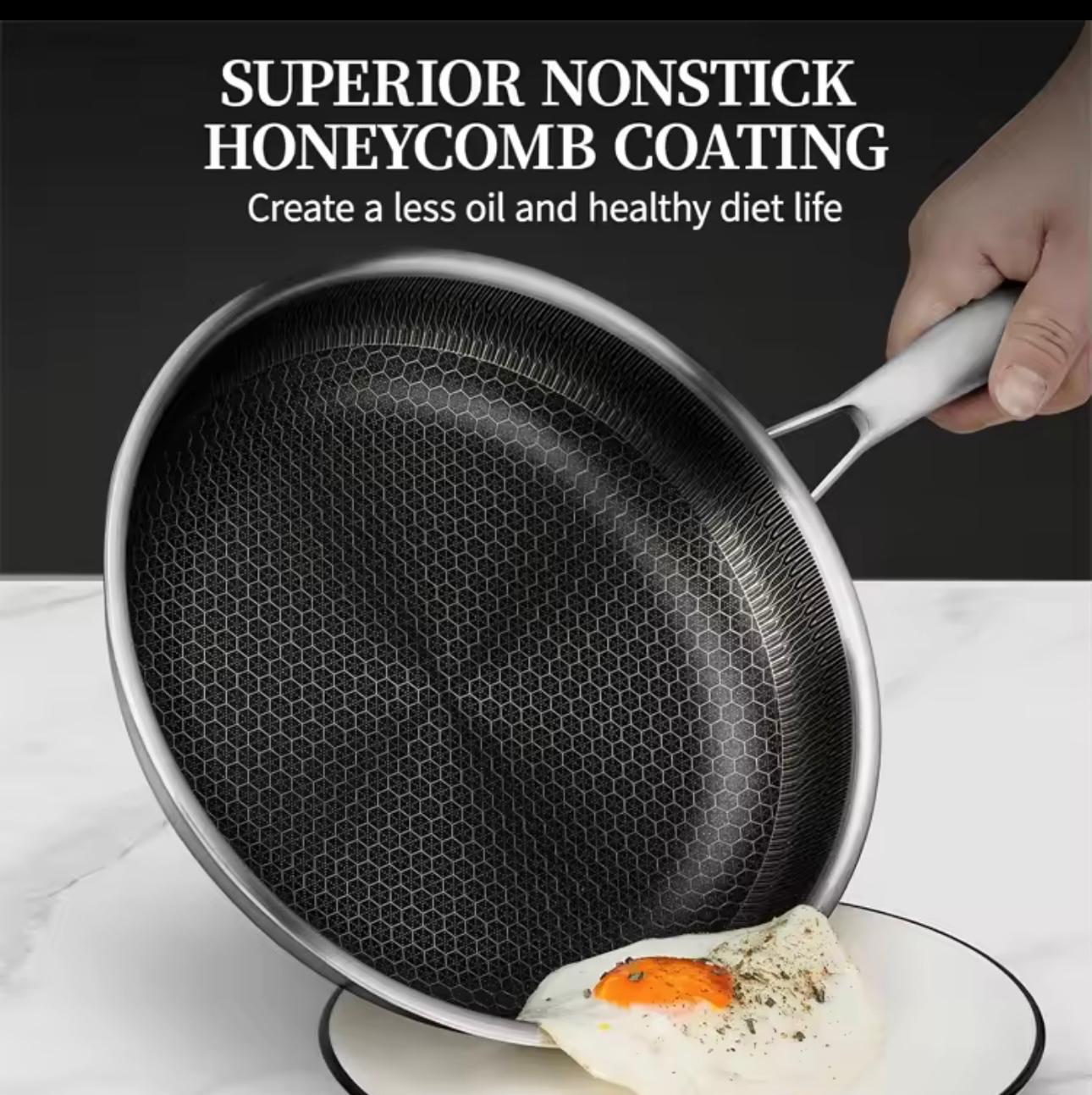 A hand holds a nonstick frying pan over a plate with a fried egg, with text at the top reading 'SUPERIOR NONSTICK HONEYCOMB COATING'.

