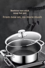 A stainless steel soup hot pot with a glass lid and a perforated inner pot, shown on a stovetop against a dark kitchen background with hanging utensils. Text at the top reads 'Beehive non-stick soup hot pot' and 'From now on, no more mush'.

