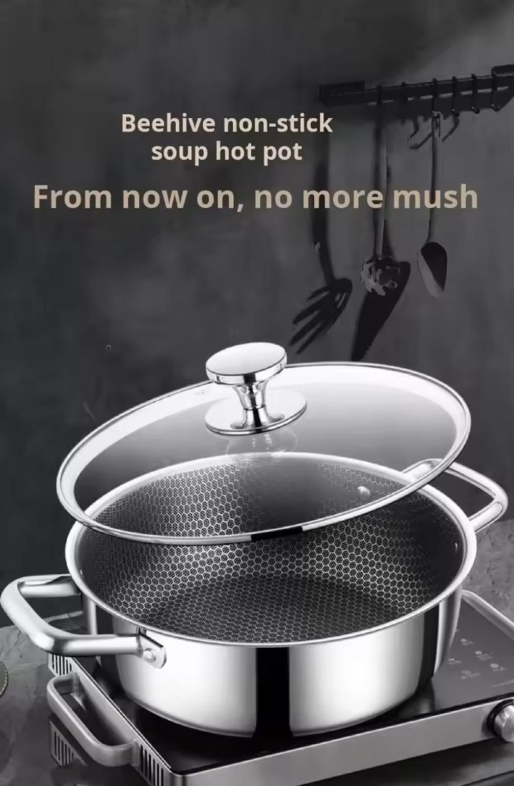 A stainless steel soup hot pot with a glass lid and a perforated inner pot, shown on a stovetop against a dark kitchen background with hanging utensils. Text at the top reads 'Beehive non-stick soup hot pot' and 'From now on, no more mush'.


