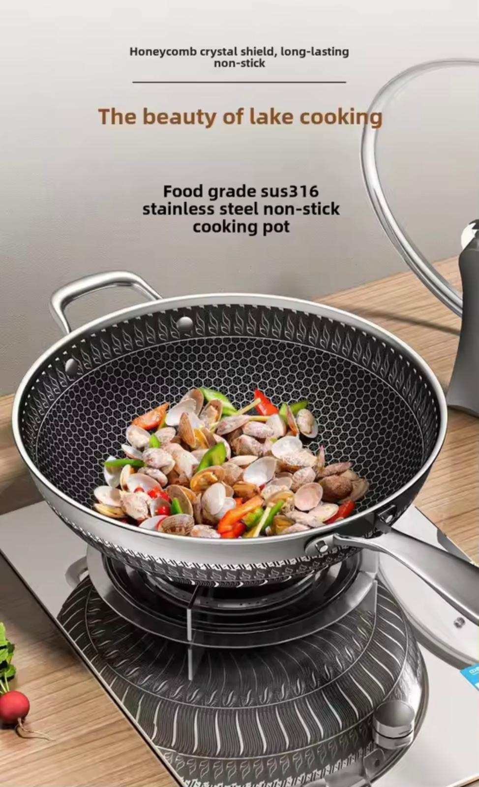A stainless steel non-stick cooking pot with a honeycomb-textured interior, shown on a stovetop with clams and vegetables cooking inside. Text at the top describes the product as a food grade sus316 stainless steel non-stick cooking pot.

