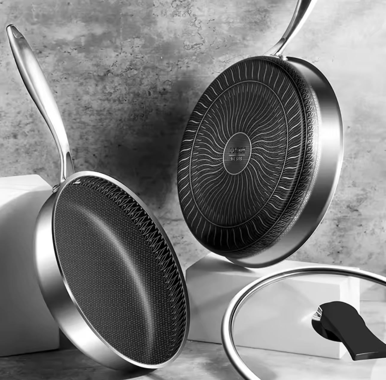 Set of frying pans with non-stick surfaces on a gray surface

