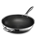 A 32cm tri-ply hybrid wok with a black honeycomb-textured non-stick interior and a silver stainless steel exterior, shown on a clean white background.

